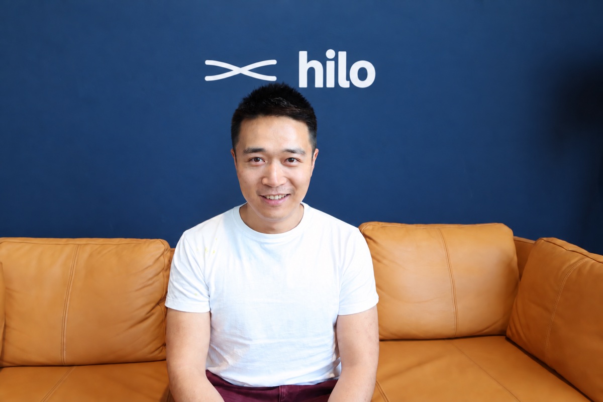 Michael Lin, founder of Finis Ventures, in front of the Hilo mark